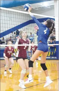  ?? Westside Eagle Observer/MIKE ECKELS ?? Lady Bulldog Giselle Fuentes (4) tips the ball over the net to Lady Pioneer Reese Hester (2) during the Decatur-Gentry varsity volleyball match in the gym at Decatur High School on Aug. 22. The Lady Bulldogs won their season opener against the Lady Pioneers, three sets to one.