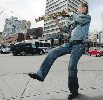  ?? DAVID BLOOM ?? Busker Quinn Wade plays the soprano saxophone on a downtown Edmonton street corner on Thursday. Now able to walk after spending 25 years in a wheelchair, Wade says “sometimes people don’t recognize me” when they see him performing on his feet these days.