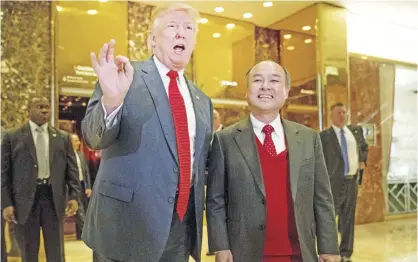  ?? — AP ?? NEW YORK: President-elect Donald Trump, accompanie­d by SoftBank CEO Masayoshi Son, speaks to members of the media at Trump Tower in New York on Tuesday, Dec 6, 2016.