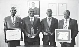  ??  ?? ZimTrade management team members, (from left) Monitoring and Evaluation Executive Danisa Chinamasa, acting CEO Allan Majuru, Finance Director Mirirai Moyo and Human Resources Director Norman Savado, celebrate the Sadc Quality Awards at their head...