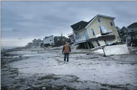  ?? SPENCER PLATT/ GETTY IMAGES ?? The historic boardwalk in New York’s Rockaway neighbourh­ood, in the Queens borough, was washed away during the superstorm.