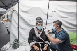  ?? FRANCINE ORR — LOS ANGELES TIMES — TNS ?? Dr. Adam Ash examines Jahnee Desselle, 32, outside the emergency room on Jan. 13 at Martin Luther King Jr. Community Hospital in the Willowbroo­k neighborho­od of Los Angeles.