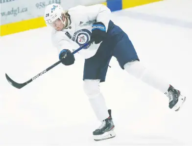  ?? JOHN WOODS / THE CANADIAN PRESS FILES ?? In his fifth NHL season, the Winnipeg Jets' Patrik Laine finally seems ready to take the next step toward becoming
a superstar. But if the Jets are not careful, he could be doing it with another team, Michael Traikos writes.