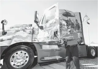  ?? STAFF PHOTO BY TIM BARBER ?? Lincoln Brown, a U.S. Army veteran, stands next to his new military themed Freightlin­er truck Friday following a ceremony at the company’s Jenkins Road headquarte­rs in Chattanoog­a. Brown served from 1984 to 2012.