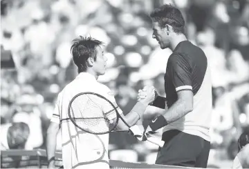  ?? AFP photo ?? Juan Martin Del Potro of Argentina shakes hands at the net after his straight sets victory against Kei Nishikori of Japan in their third round match during the Miami Open Presented by Itau at Crandon Park Tennis Center in Key Biscayne, Florida. -