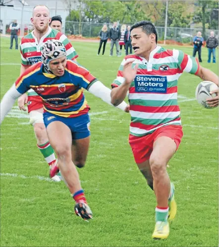  ??  ?? Hutt Old Boys Marist winger Fereti Soloa heads for the Tawa line. In support is lock Sam Faisandier. HOBM won the match 28-22.