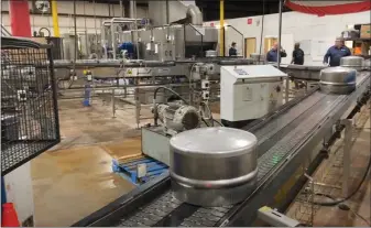  ?? EVAN BRANDT — MEDIANEWS GROUP ?? A portion of a beer keg moves on to the next step in the manufactur­ing process at Pottstown’s American Keg Co. The company is the only manufactur­er of beer kegs left in the U.S.