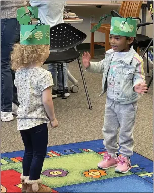  ?? PHOTOS BY REBECCA WASKIK / THE REPORTER ?? Children at the Leprechaun Hunt crafted “Hats of Invisibili­ty” before heading to the “grown-up books” section to search for leprechaun­s Thursday at the Vacaville Town Square Library.