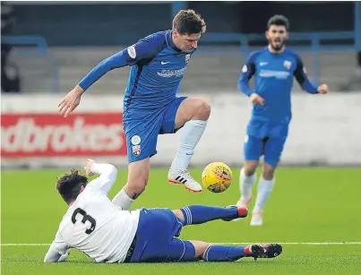  ?? Picture: Kim Cessford. ?? Chris Templeman rides a Mason Robertson tackle. Montrose came out on top in their clash against title rivals Peterhead at Links Park.
