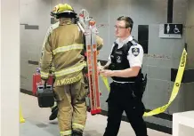  ?? GAVIN YOUNG ?? Firefighte­rs enter a washroom in Calgary’s Core Shopping Centre food court after a body was found on Monday.