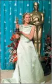  ?? MARK J. TERRILL — THE ASSOCIATED PRESS FILE ?? Kim Basinger wears an Escada gown as she holds the Oscar for best supporting actress for her role in “L.A. Confidenti­al,” at the 70th Academy Awards in Los Angeles.