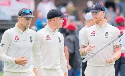  ?? Picture: AP. ?? England captain Joe Root, left, Ollie Pope and Ben Stokes, right, leave the field of play after winning the third Test between South Africa and England in Port Elizabeth.
