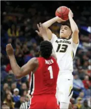  ?? JEFF ROBERSON — THE ASSOCIATED PRESS FILE ?? In this file photo, Missouri’s Michael Porter Jr. (13) shoots over Georgia’s Yante Maten during the first half in an NCAA college basketball game at the Southeaste­rn Conference tournament, in St. Louis. Michael Porter Jr. played in three games in...