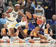  ?? Patrick McDermott / Getty Images ?? UConn’s Andre Jackson dribbles the ball against Marquette’s Justin Lewis in the first half at Fiserv Forum on Tuesday in Milwaukee.