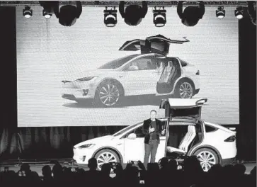  ?? LiPo Ching
TNS ?? TESLA CEO Elon Musk shows off the falcon wing design of the Model X SUV crossover in its debut from the f loor of Tesla’s plant in Fremont, Calif., in September. Musk says he hopes for positive cash f low in early 2016.