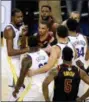  ?? BEN MARGOT — THE ASSOCIATED PRESS ?? Cleveland Cavaliers center Tristan Thompson, top, yells at Golden State Warriors forward Draymond Green, bottom, during overtime of Game 1 of basketball’s NBA Finals in Oakland, Calif., Thursday.