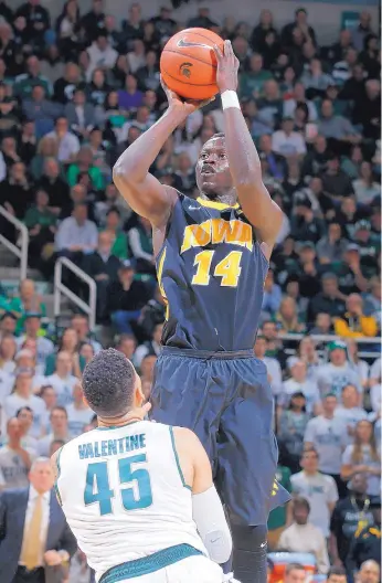  ?? AL GOLDIS/THE ASSOCIATED PRESS ?? Iowa’s Peter Jok (14) shoots over Denzel Valentine of Michigan State during the first half of Thursday’s game. Jok scored 19 of his 23 points in the first half.