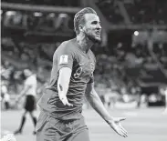  ?? Matthias Hangst / Getty Images ?? Harry Kane celebrates his stoppage-time goal that allowed England to slip past Tunisia.