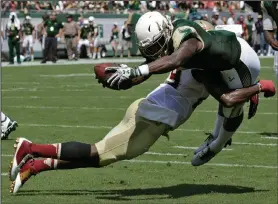  ?? AP PHOTO ?? South Florida running back Marlon Mack (5) is stopped by Florida State defensive back A.J. Westbrook as he tries to stretch over the goal line.