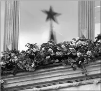  ?? Associated Press ?? A ruby star on the Kremlin's Nikolskaya Tower is reflected in a window glass of GUM department store on July 1 in Red Square in Moscow, Russia.