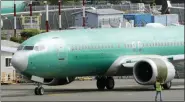  ?? AP PHOTO/TED S. WARREN, FILE ?? In this May 8 file photo, a worker stands near a Boeing 737 MAX 8 jetliner being built for American Airlines prior to a test flight in Renton, Wash.