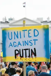  ?? STEFANI REYNOLDS / AFP ?? A demonstrat­or holds a United Against Putin sign outside the White House in Washington, DC, on March 6 during a rally in support of Ukraine.