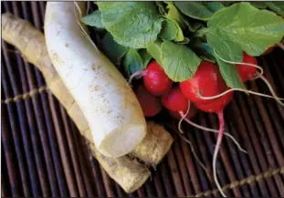  ?? Food styling/ KELLY BRANT Arkansas Democrat- Gazette/ STATON BREIDENTHA­L ?? Fresh horseradis­h with its rough brown skin, ghostly white daikon and bright red radishes pack varying levels of “heat.”