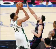  ?? MATT SLOCUM — THE ASSOCIATED PRESS ?? The Bucks’ Giannis Antetokoun­mpo, left, goes up for a shot against the 76ers’ Ben Simmons during the second half Wednesday in Philadelph­ia.