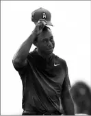  ??  ?? TIGER WOODS TIPS HIS CAP after finishing on the ninth hole during the first round of the Honda Classic golf tournament Thursday in Palm Beach Gardens, Fla.