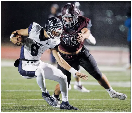  ?? File photo/Arkansas Democrat-Gazette/THOMAS METTHE ?? Greenwood quarterbac­k Jace Presley avoids the pass rush of Benton defensive end Brett Barbaree (95) on Oct. 25 at Panther Stadium in Benton. Presley, in his first season as the starting quarterbac­k for the Bulldogs, led the team to the No. 2 seed in the 6A-West Conference. Greenwood earned a first-round bye for the playoffs.