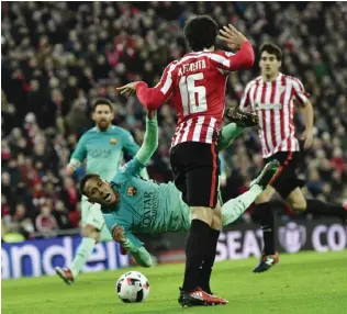  ??  ?? BILBAO: Barcelona’s Neymar falls to the ground as he vies for the ball with Athletic Bilbao’s Xabier Etxeita during the Spanish Copa del Rey match at San Mames stadium on Thursday. — AP