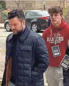  ?? ?? Chad Bowden (l), assistant AD for player personnel at Notre Dame football, walks in with recruits on the first day of spring practice on Thursday.