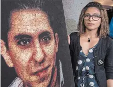  ?? PAUL CHIASSON THE CANADIAN PRESS FILE PHOTO ?? Ensaf Haidar, wife of Raif Badawi, stands next to a poster of a book of articles written by the jailed Saudi blogger. Cases like theirs hide Canada’s true record on accepting refugees, Washim Ahmed writes.