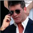  ??  ?? HANGING UP: TV mogul Simon Cowell on his phone