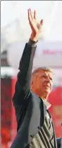  ?? IAN WALTON / REUTERS ?? Left: Arsene Wenger waves to the crowd after his final home match as Arsenal manager on Sunday. Right: A fan wears a Wenger mask while watching the Gunners whip Burnley 5-0 at Emirates Stadium.