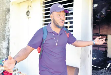  ?? KENYON HEMANS/ PHOTOGRAPH­ER ?? Michael McLean, the brother of two occupants of a house that was destroyed by fire, laments the tragedy that unfolded in the wee hours of Thursday morning. The blaze gutted the home located in the community of ‘Mexico’ in Arnett Gardens, south St Andrew.