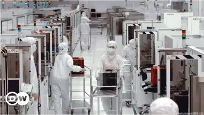  ??  ?? Full protective gear is more than a pandemic requiremen­t in Taiwan's semiconduc­tor industry