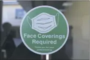  ??  ?? Pleasant Valley High put tiny stickers on several windows reminding students to wear face coverings. Aside from that, the campus looked the same Wednesday in Chico.