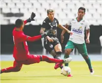  ?? RICARDO MORAES/REUTERS ?? Botafogo’s Bruno Nazario scores the team’s fourth goal against Cabofriens­e on Sunday in Rio de Janeiro following the resumption of play in front of empty stands.