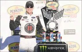  ?? Brian Lawdermilk / Getty Images ?? Kevin Harvick poses with the Monster Energy NASCAR Cup Series Pennzoil 400 championsh­ip trophy at Las Vegas Motor Speedway on Sunday in Las Vegas, Nevada.