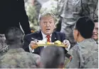  ?? OLIVIER DOULIERY/ AFP VIA GETTY IMAGES ?? President Trump serves Thanksgivi­ng dinner to U. S. troops in Afghanista­n.