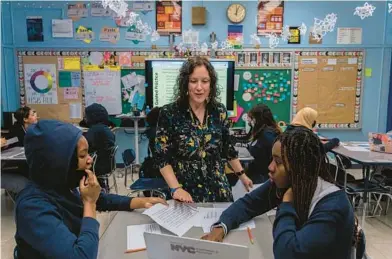  ?? HIROKO MASUIKE/THE NEW YORK TIMES ?? Marisa Shuman with some of her students Jan. 19 at a school in the Bronx borough of New York.