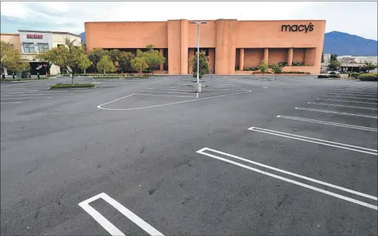  ?? Frederic J. Brown AFP/Getty Images ?? THE MACY’S parking lot at the Westfield Santa Anita mall in Arcadia sits empty. The retailer announced last week that it was moving all sales online for now.