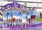  ?? MARTIN RICKETT/PA VIA AP ?? Manchester City’s Ilkay Gundogan lifts the Premier League trophy May 21 after their English Premier League title win against Chelsea at the Etihad Stadium in Manchester, England.