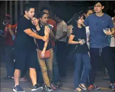  ?? Aaron Favila/Associated Press ?? Relatives of victims grieve Friday as they receive news of their loved ones at a hotel at the Resorts World Manila complex in Manila, Philippine­s.