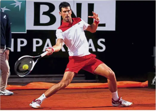  ?? — Reuters ?? Focused: Novak Djokovic returning a shot to Albert Ramos-Vinolas during the third round of the Italian Open on Thursday.