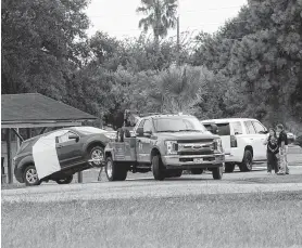  ?? Marie D. De Jesús / Staff photograph­er ?? A vehicle is removed from Comanche Boulevard near Texas 36 on Tuesday. A husband and wife were found fatally shot nearby inside their home, officials said. Investigat­ors are still trying to piece together the shooting timeline.