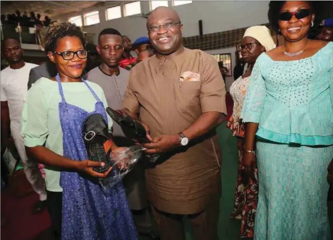  ??  ?? Ikpeazu (middle)...displaying Made-in-Aba leather sandals produced by a female shoe maker