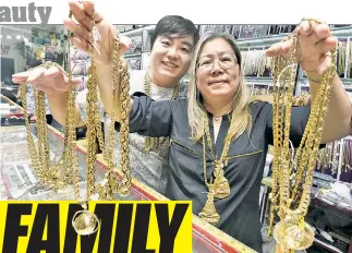  ??  ?? Eva Sam and her son, William Wong, sell high-style bling to high-rolling hip-hoppers at Popular Jewelry in Chinatown.