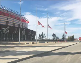  ??  ?? Flags fly at half-mast at the Canadian Tire Centre on Monday, in honour of Alex Trebek.